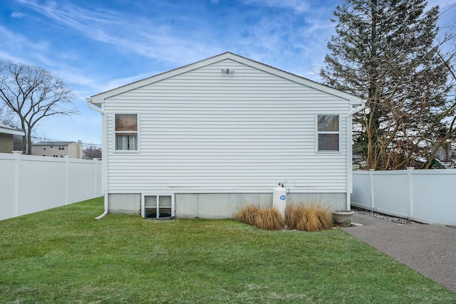 view of side of home featuring a yard