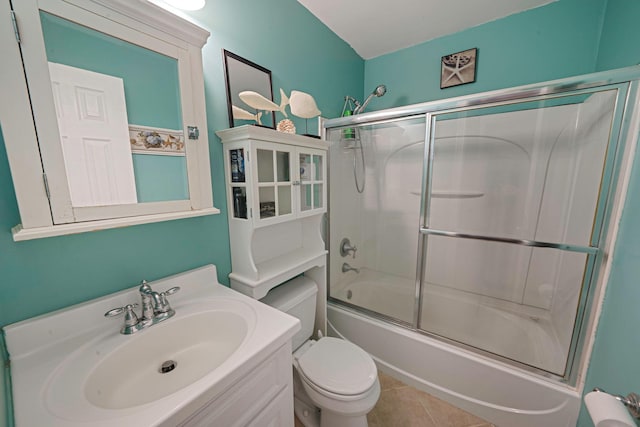 full bathroom with toilet, tile patterned floors, shower / bath combination with glass door, and vanity