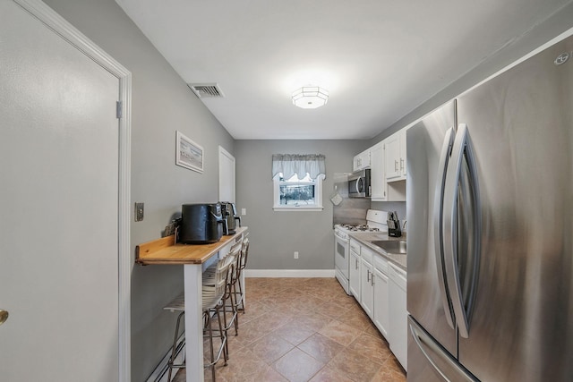 kitchen with stainless steel appliances and white cabinets