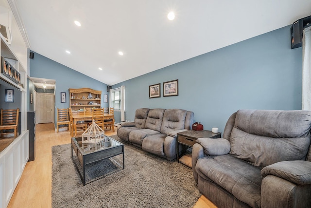 living room with vaulted ceiling and light hardwood / wood-style floors