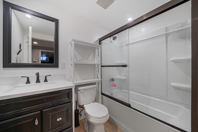 full bathroom featuring tile patterned flooring, vanity, toilet, and combined bath / shower with glass door