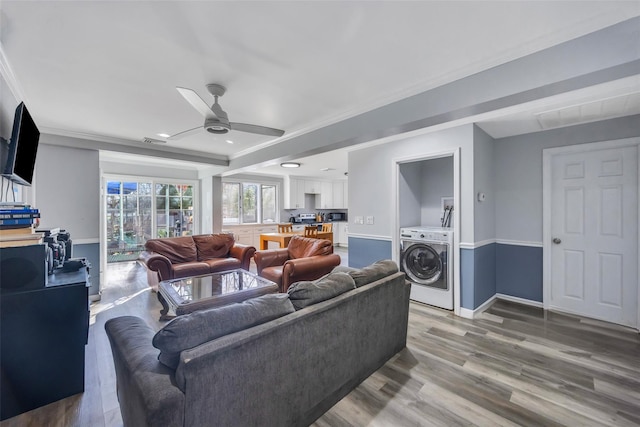 living room with hardwood / wood-style flooring, ornamental molding, washer / dryer, and ceiling fan