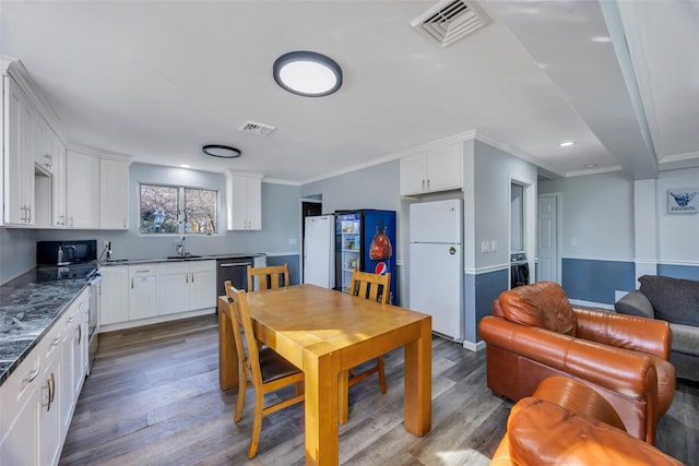 dining space featuring crown molding and wood-type flooring