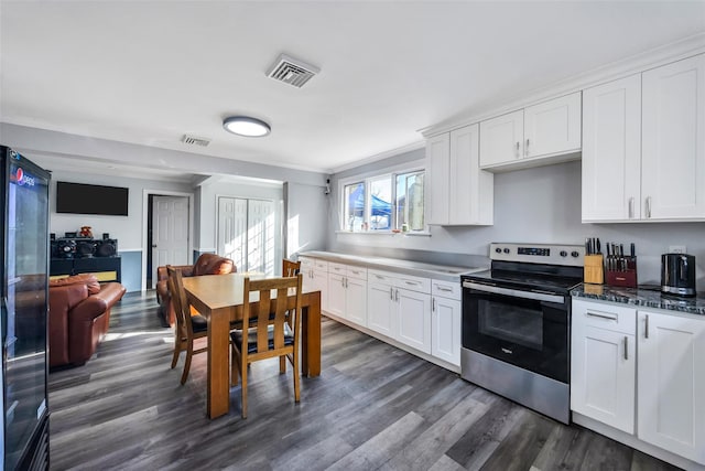 kitchen featuring crown molding, stainless steel electric stove, and white cabinets