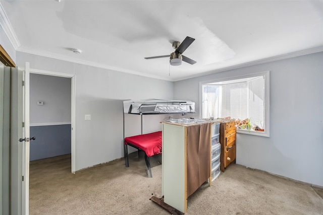 carpeted bedroom with ornamental molding and ceiling fan