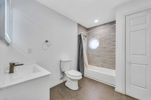 full bathroom featuring shower / tub combo with curtain, vanity, tile patterned flooring, and toilet