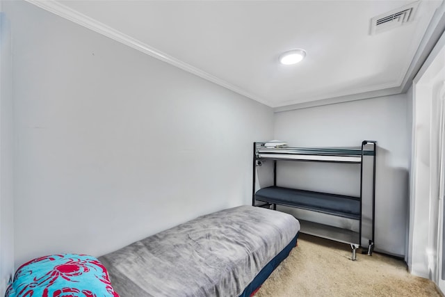 bedroom featuring ornamental molding and carpet flooring