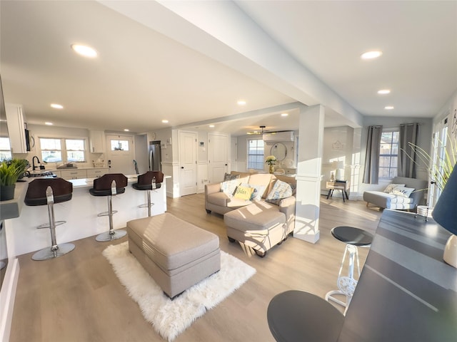 living room with sink and light wood-type flooring