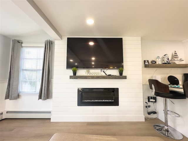 interior details featuring a baseboard heating unit, beam ceiling, and wood-type flooring