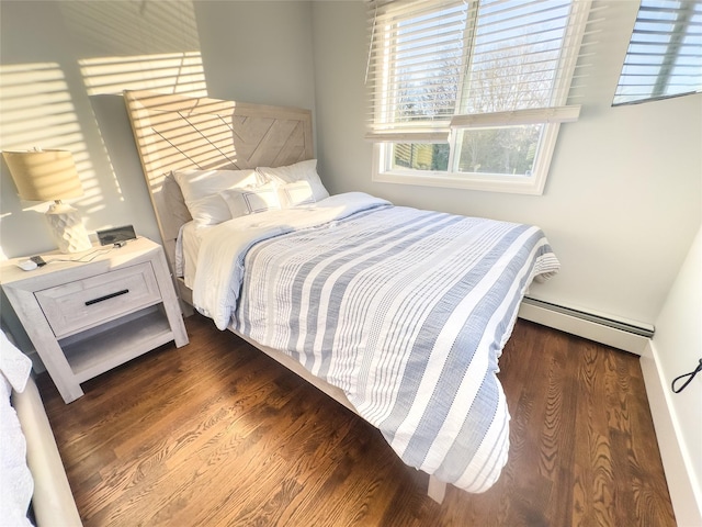 bedroom with baseboard heating and dark hardwood / wood-style floors