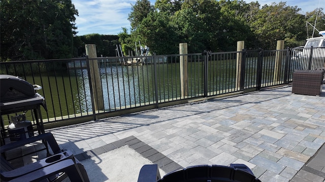 view of patio with a water view