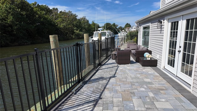 view of patio featuring a water view, an outdoor hangout area, and french doors