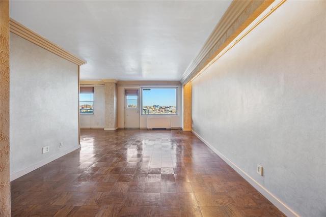 spare room featuring crown molding and dark parquet floors