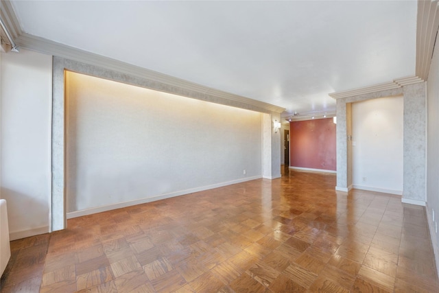 empty room with crown molding and parquet flooring