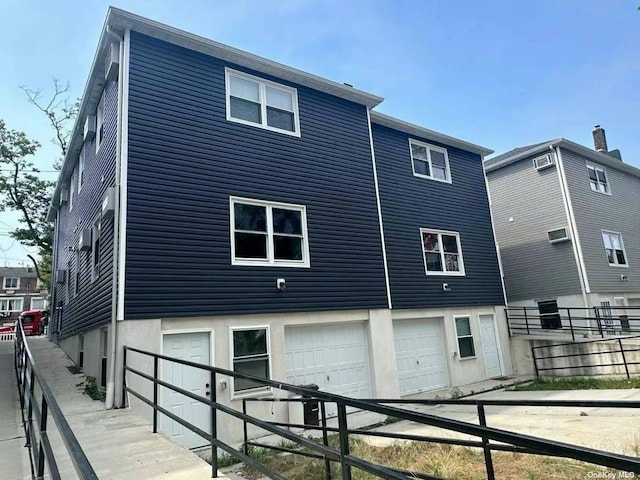 rear view of house featuring a garage