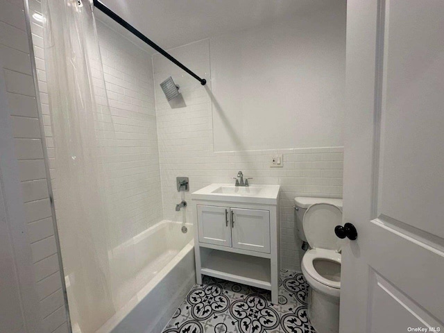 full bathroom featuring tile walls, vanity, toilet, shower / bathtub combination with curtain, and tile patterned floors