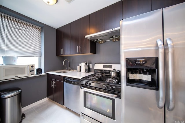 kitchen featuring stainless steel appliances, sink, and dark brown cabinetry