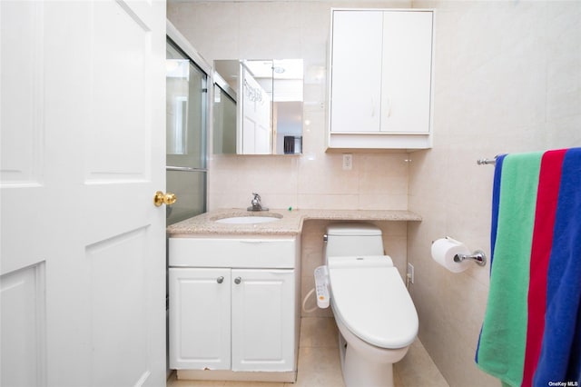 bathroom with walk in shower, toilet, tile walls, vanity, and backsplash