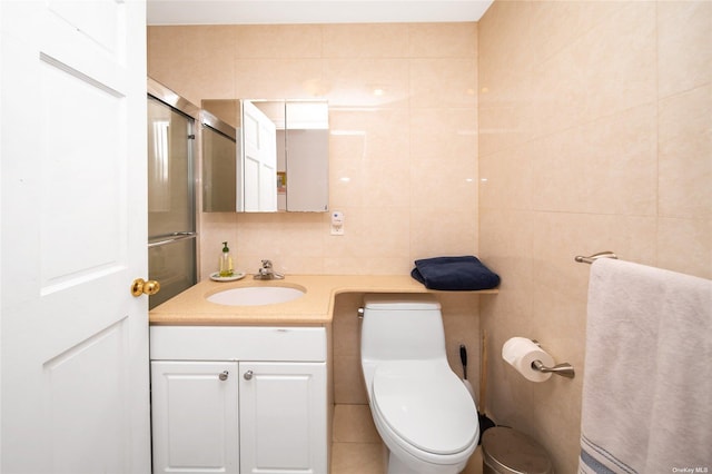 bathroom with toilet, a shower with shower door, tile walls, vanity, and backsplash