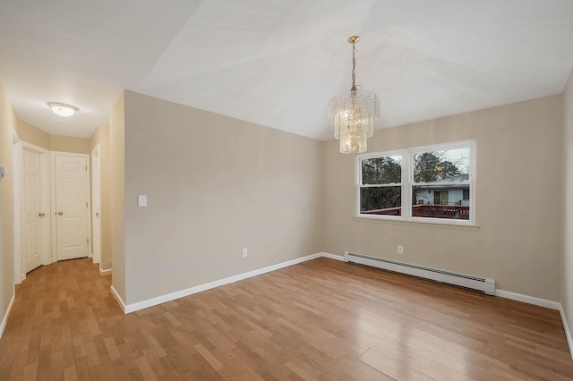 unfurnished room featuring vaulted ceiling, a baseboard heating unit, a notable chandelier, and light wood-type flooring