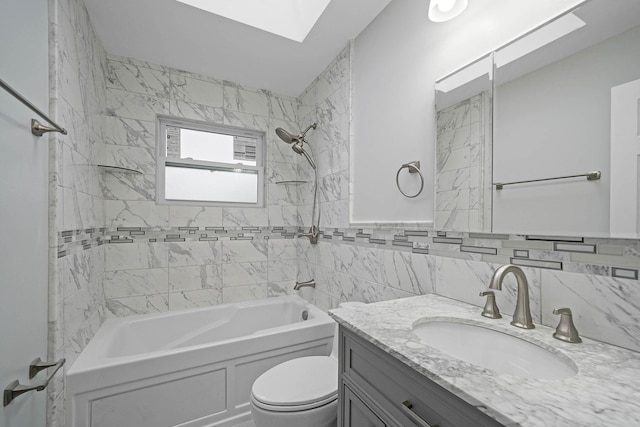 full bathroom with tile walls, tiled shower / bath combo, a skylight, vanity, and toilet