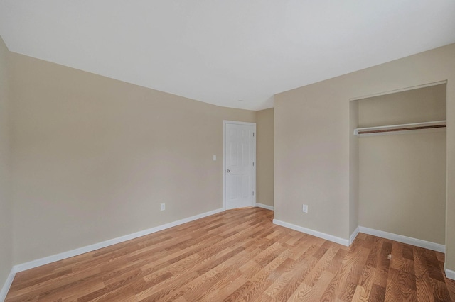 unfurnished bedroom with a closet and light hardwood / wood-style flooring