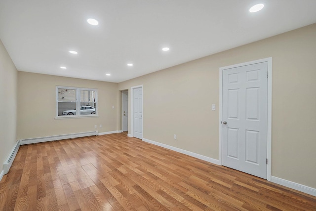 spare room featuring light hardwood / wood-style flooring and a baseboard heating unit