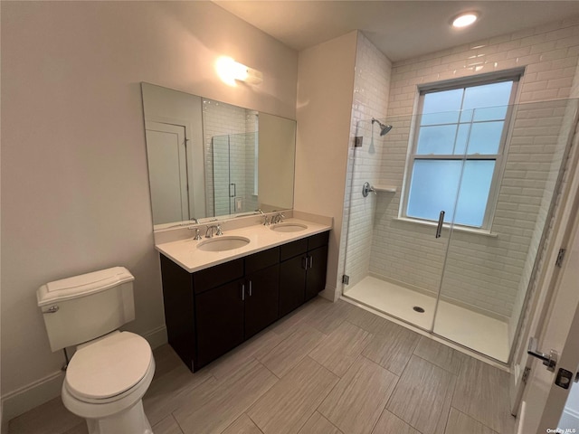 bathroom featuring vanity, an enclosed shower, and toilet