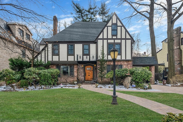 tudor home featuring a front yard