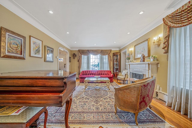 living room with crown molding and light hardwood / wood-style floors