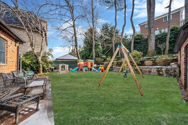 view of yard with a playground and a patio