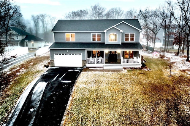 view of front facade with a garage and covered porch