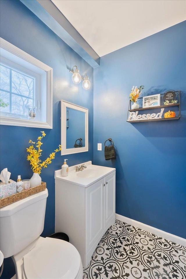 bathroom featuring tile patterned flooring, vanity, and toilet