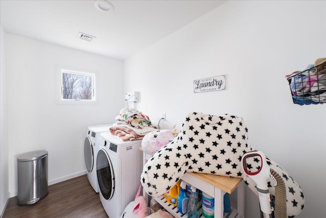 laundry area featuring dark wood-type flooring and washing machine and clothes dryer