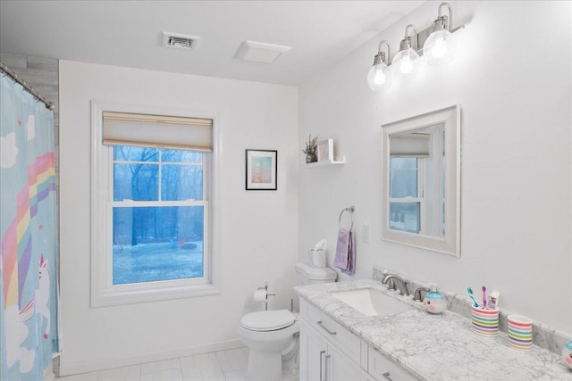 bathroom featuring vanity and toilet