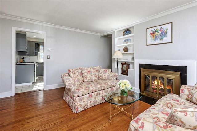 living room featuring crown molding and hardwood / wood-style floors