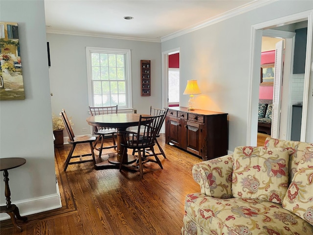 dining room with crown molding and hardwood / wood-style flooring