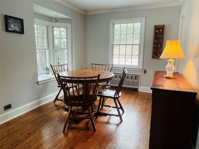 dining space with crown molding, radiator heating unit, and dark hardwood / wood-style flooring