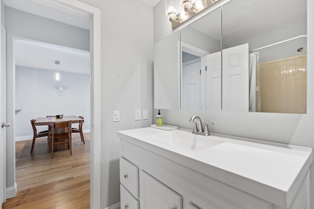 bathroom with vanity, a shower with shower curtain, and wood-type flooring