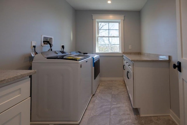 laundry room with cabinets and washer and dryer