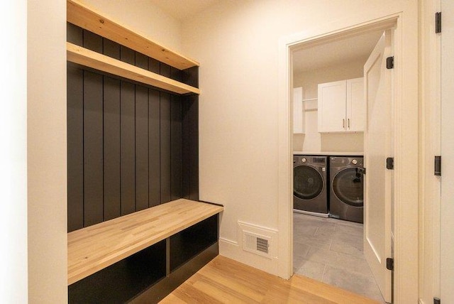 mudroom featuring light hardwood / wood-style flooring and washing machine and dryer