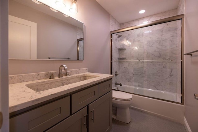 full bathroom with vanity, combined bath / shower with glass door, and toilet