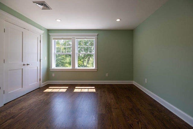 unfurnished bedroom with dark wood-type flooring