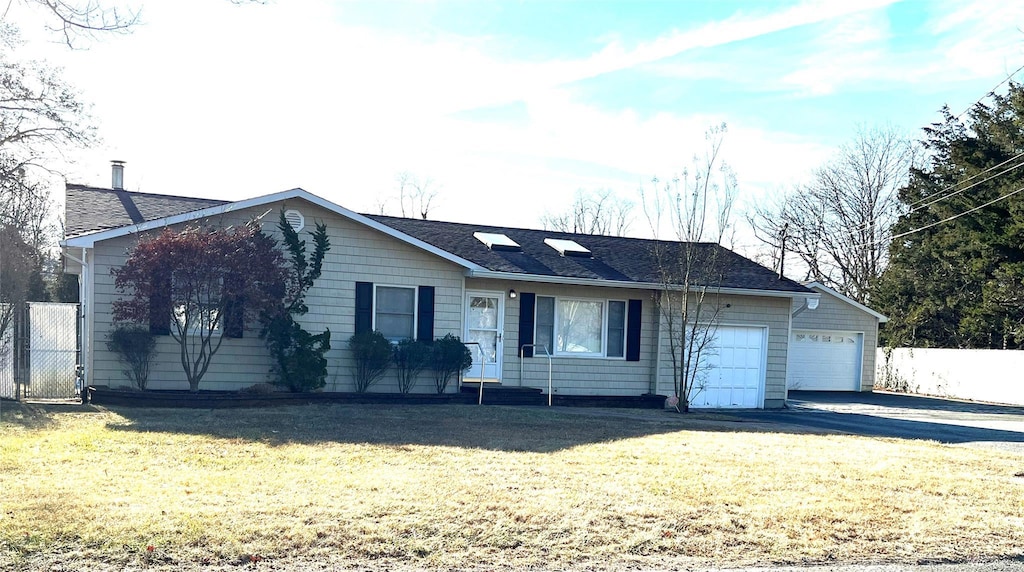 single story home featuring a garage and a front yard