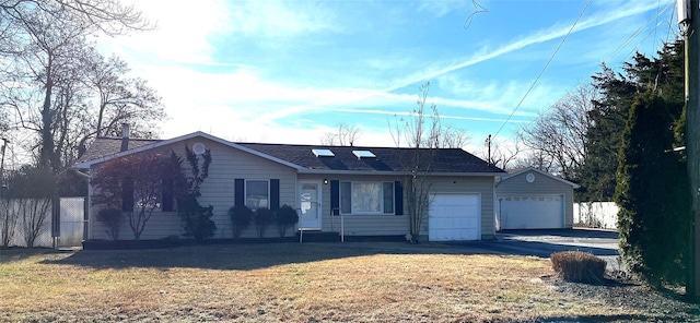 single story home featuring a garage and a front yard