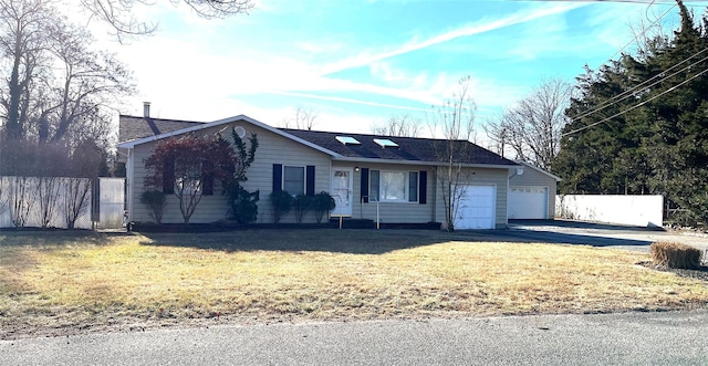 ranch-style home featuring a garage and a front lawn