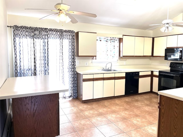 kitchen featuring black appliances, sink, light tile patterned floors, ceiling fan, and kitchen peninsula