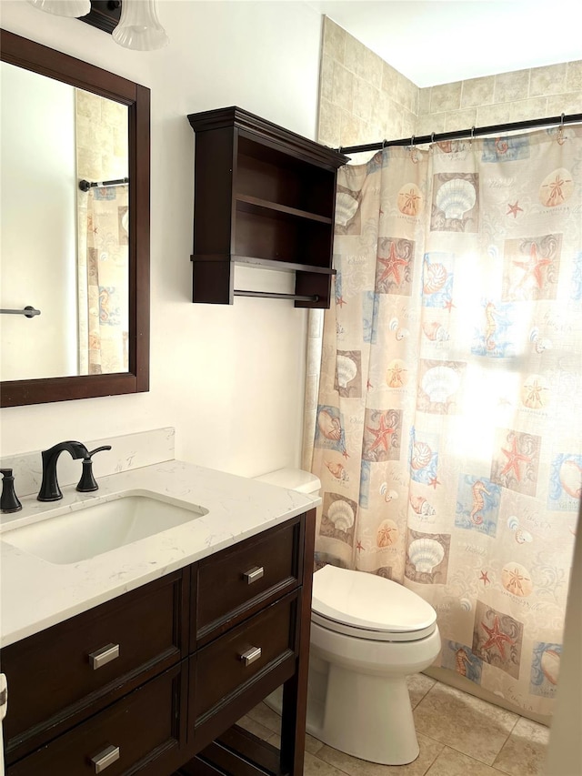 bathroom featuring tile patterned flooring, vanity, walk in shower, and toilet