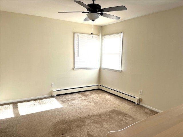 spare room featuring a baseboard radiator, carpet floors, and ceiling fan