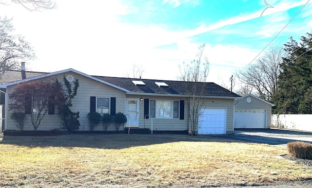 ranch-style house with a garage and a front yard